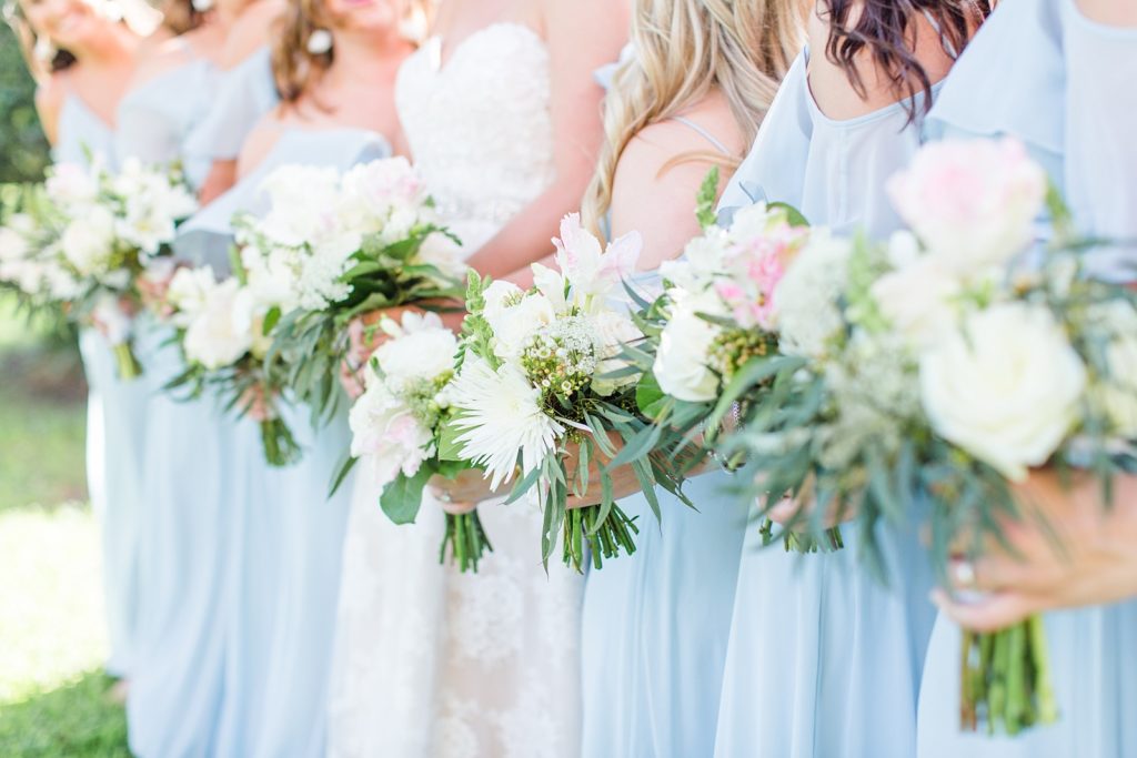 Bridesmaids and bride holding bouquets from MLS Floral