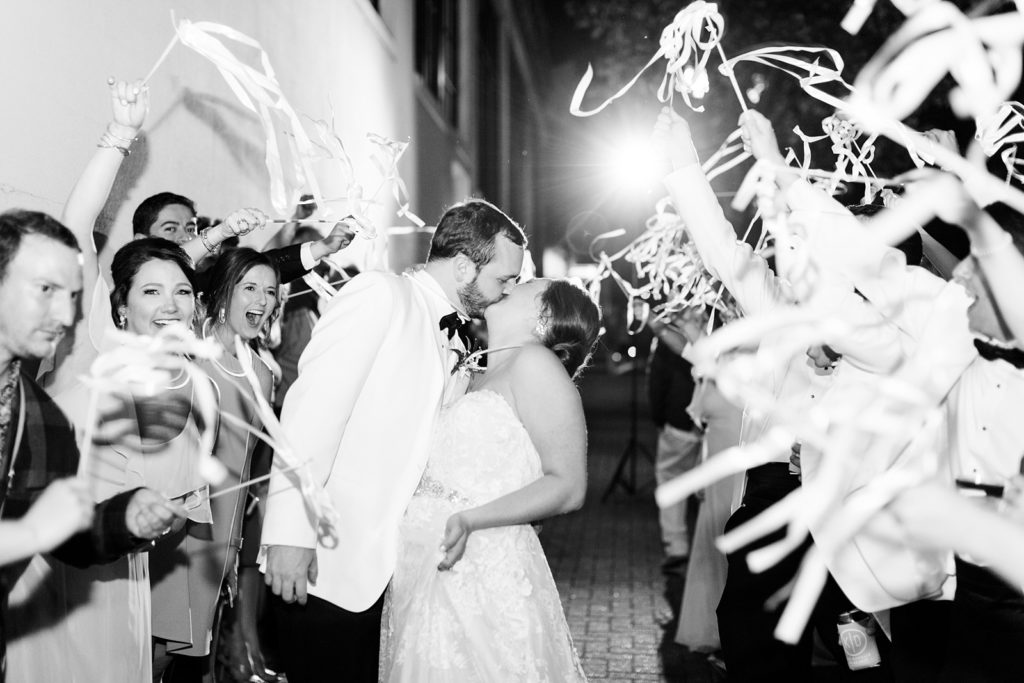 Bride and Groom exit with streamers and kiss