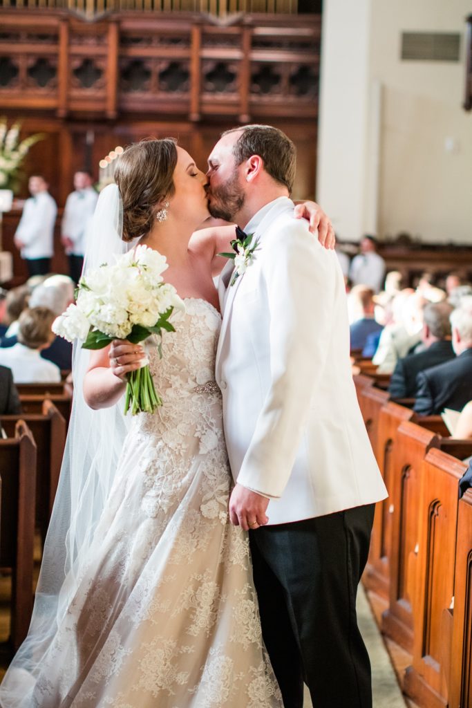 Bride and groom share a kiss after recessing down the aisle at First Presbyterian Church Shreveport